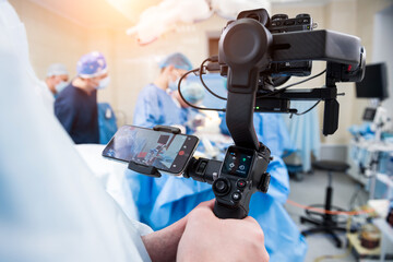 The videographer shoot the surgeon and assistants in the operating room with surgical equipment