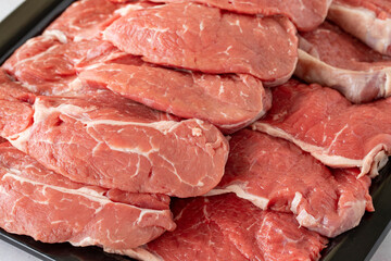 raw steak on white wooden background. Boneless beef entrecote. Meat background. Close-up beef anricot meat