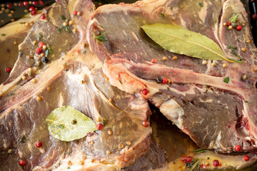 Marinated beef t-bone steak on white wood background. Meat background. Meat close-up