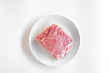 sliced raw pork meat isolated on white background ready for cooking. a piece of pork