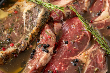 Marinated beef t-bone steak on white wood background. Meat background. Meat close-up