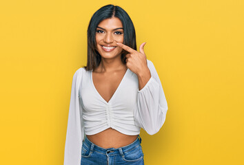 Young latin transsexual transgender woman wearing casual clothes pointing with hand finger to face and nose, smiling cheerful. beauty concept