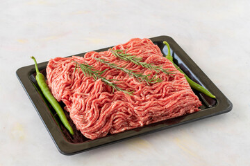 Raw Ground beef on white wooden background. Minced Meat background.