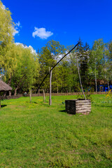 Old traditional wooden shadoof in village in Ukraine