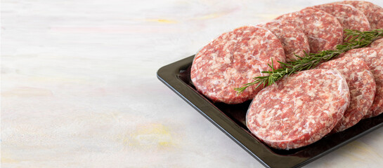 packaged raw beef burger meat on white wooden background. Meat background. Copy space
