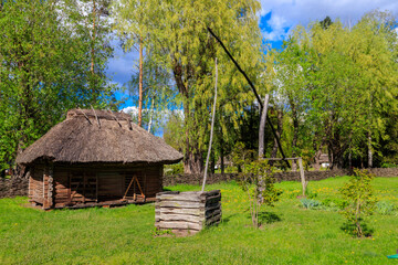 Fototapeta na wymiar Old traditional wooden shadoof in village in Ukraine