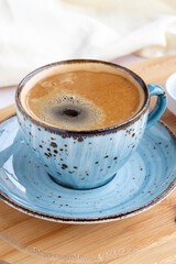 A cup of coffee on a white wooden background. Local name filtre kahve