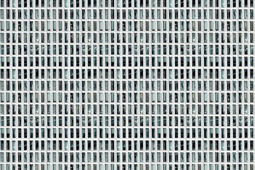 Facade of skyscraper with elongated rectangular windows, abstract colorless image, composite,...