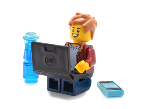 Minde om Ejendommelige faktor Lego minifigure isolated on white is surfing in internet on black laptop.  Editorial illustrative image of home schooling or home office. Stock-foto |  Adobe Stock