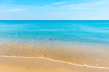 Fototapeta na wymiar Blue sea water and sand beach with blue sky