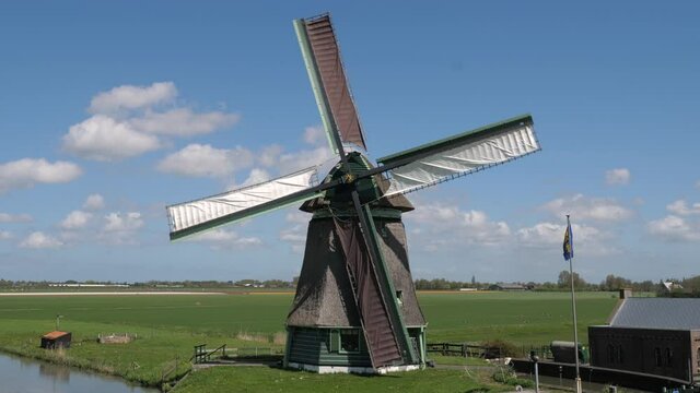 Historical windmill in Dutch landscape with beautiful clouds