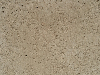 Pattern of light beige decorative and textured plaster. Construction and finishing materials for repairs of walls in apartments, houses and offices. Background and texture for design and decoration.