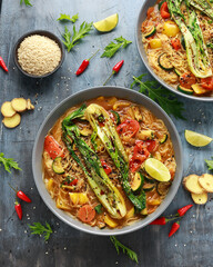 Asian style Pak choi, lemongrass, and ginger curried noodles served with lime wedges
