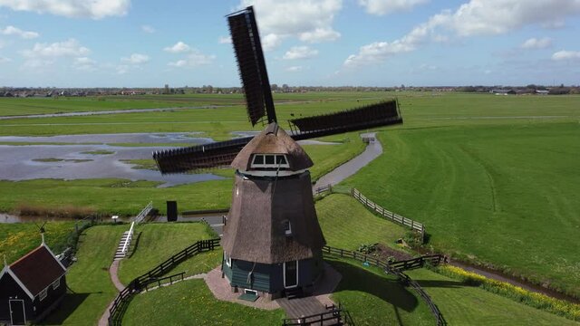 Historical windmill in Dutch landscape with beautiful clouds