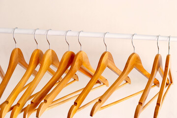 Empty wooden clothes hangers on aluminum rail