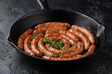 Homemade Pork Sausages in rustic pan with thyme