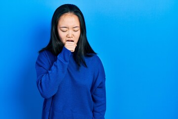 Young chinese girl wearing casual clothes feeling unwell and coughing as symptom for cold or...