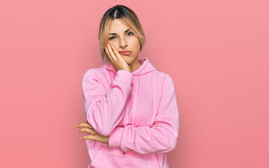 Young caucasian woman wearing casual sweatshirt thinking looking tired and bored with depression...
