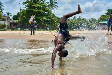 african teens play on the beach - obrazy, fototapety, plakaty