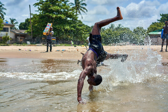 Naklejki african teens play on the beach