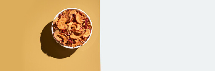 Crispy dried food. Organic tasty chips. Homemade snacks. Sliced apples. Healthy fruit. Two area. Orange pile. Trend natural dish. Horizontal banner. Copyspace