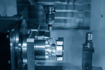 The 4-axis simultaneous machining center tapping the motorcycle gear case parts on the  rotary table. The hi-precision automotive manufacturing process by multi-axis CNC milling machine.
