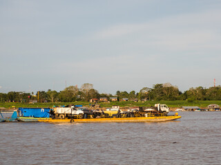 Santa Rosa, Peru - Dec, 2017: Transportation  many cars across the Amazon River on the floating...