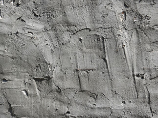 irregular surface of fresh cement with spatula texture - messy gray background