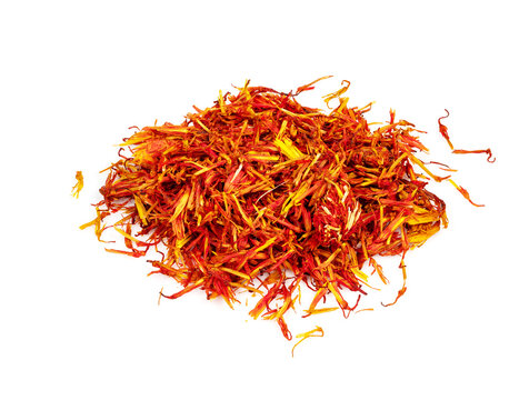 handful of dried safflower petals closeup on white