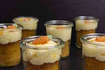 carrot cake in a glass jar with cream cheese buttercream