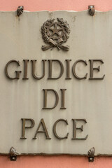Justice of the peace, posted in stone on the facade of a building in Benevento. - obrazy, fototapety, plakaty