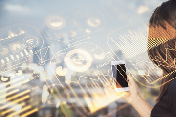 Double exposure of tech icon hologram and woman holding and using a mobile device. Technology...