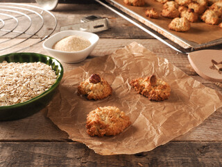 Oatmeal cookies on baking paper with organic baking ingredients
