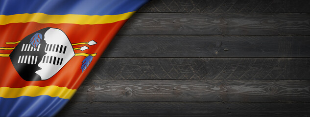 Swaziland flag on black wood wall banner