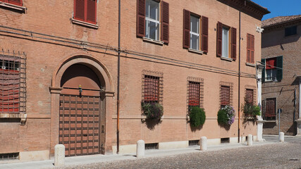 Ferrara, Italy. Corso Ercole I d'este, cobbled avenue in the Renaissance part of the town. An elegant house with flowers on the windowsills.