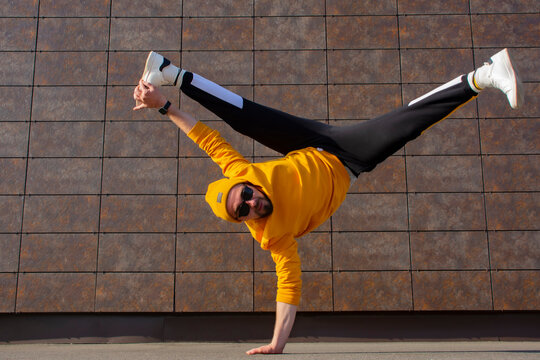 Man street Break Dancer is Dancing in the street. BBOY makes an acrobatic element Flare.
