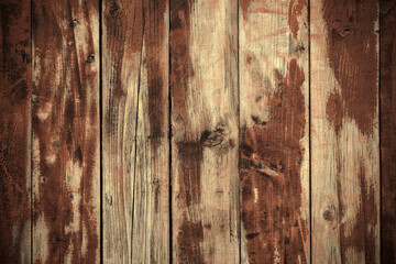 Photo the texture of a wooden wall made of planks with remnants of stripped red paint