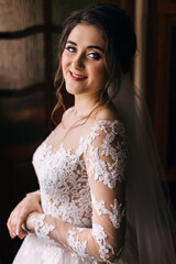 Naklejka premium elegant woman with wavy hair. Beautiful face with delicate makeup, shiny eyes. Evening festive image of the bride