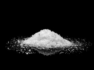 Sugar or Sea Salt on black background.