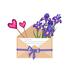 Iris flowers in a craft envelope with a love note and heart-shaped lollipops, ribbon with a bow. Gift delivery. Festive decoration for wedding, party and romantic event