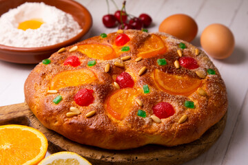 Coca de sant joan. Traditional San Juan cake to celebrate the arrival of summer in Spain made with brioche bread, candied fruit and nuts.