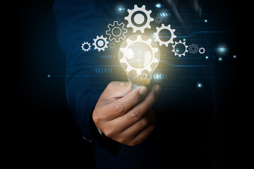 Businessman holding light bulb with a gear icon.  innovation idea concept.