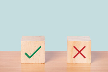 True and false symbols accepted rejected on wood cubes.
