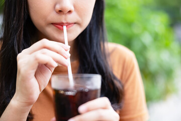 closeup woman drinking ice cola. food and beverage concept.