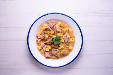 Pork cooked with potatoes and onion