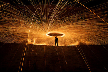 Spinning burning steel wool. Light painting at night. Perfect orange fire show.