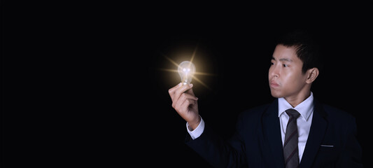 Businessman holding lightbulb.
