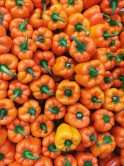 Lots of fresh orange peppers. Yellow pepper texture