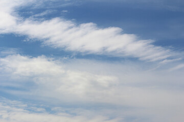 Clouds on bright blue sky background