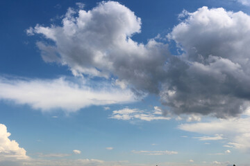 Clouds on bright blue sky background
